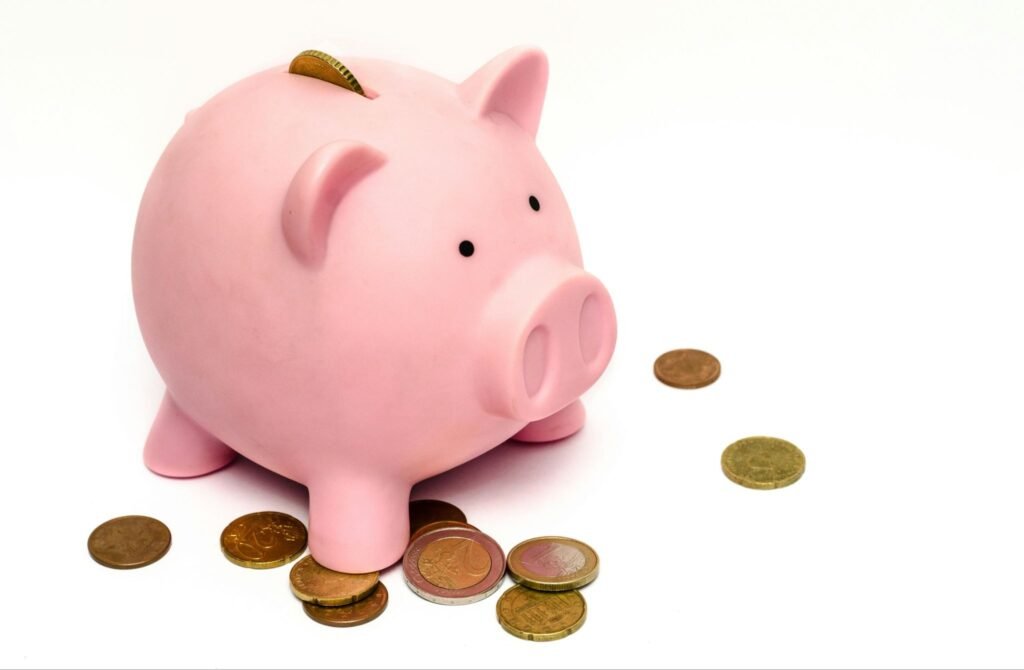 piggy bank with money around it