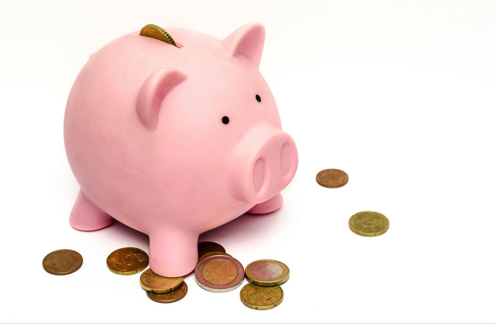 piggy bank with money around it